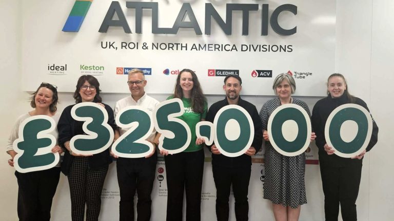 Ideal Heating’s HR Director Miriam Moore, second right, with Hannah Wragg, centre, Macmillan Cancer Support’s Relationship Fundraising Manager, celebrating £325,000 raised for the charity with Ideal team members.